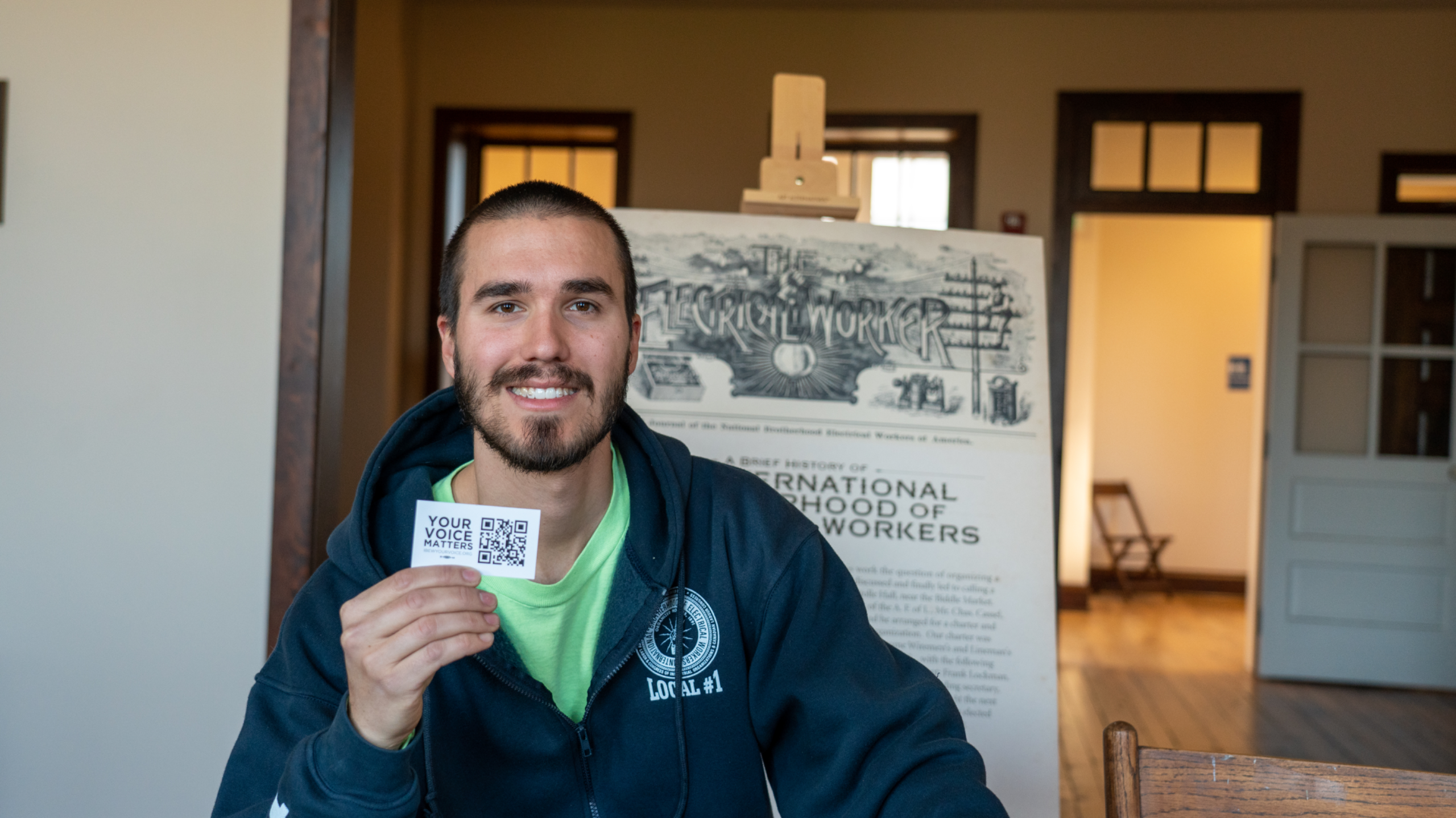 IBEW member holding union card